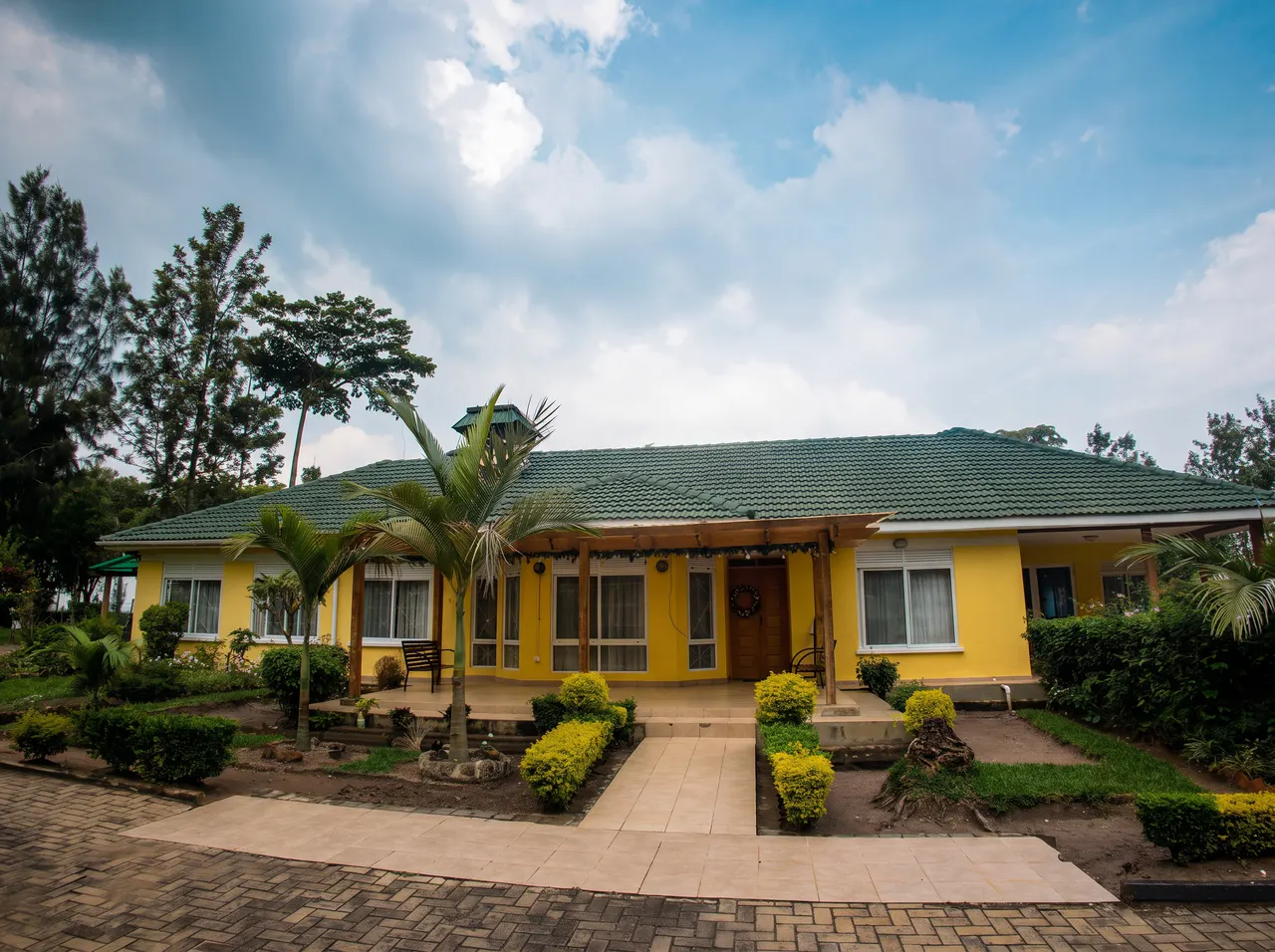 The main yellow guesthouse and gardens at The Nyakaju.