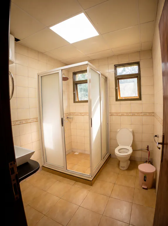 Deluxe tiled bathroom with an enclosed shower.