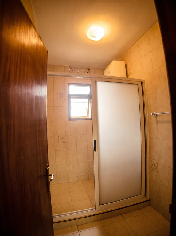 Elite bathroom with an enclosed shower.