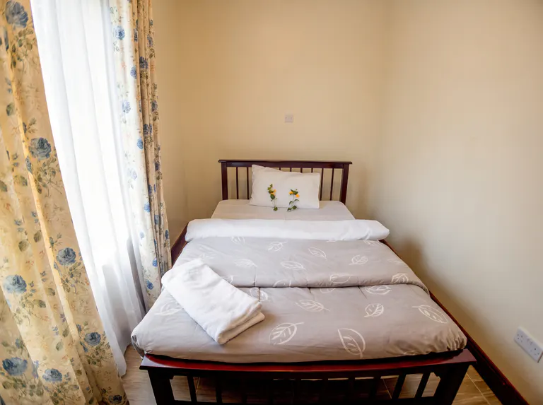 Royal bedroom with floral curtains.